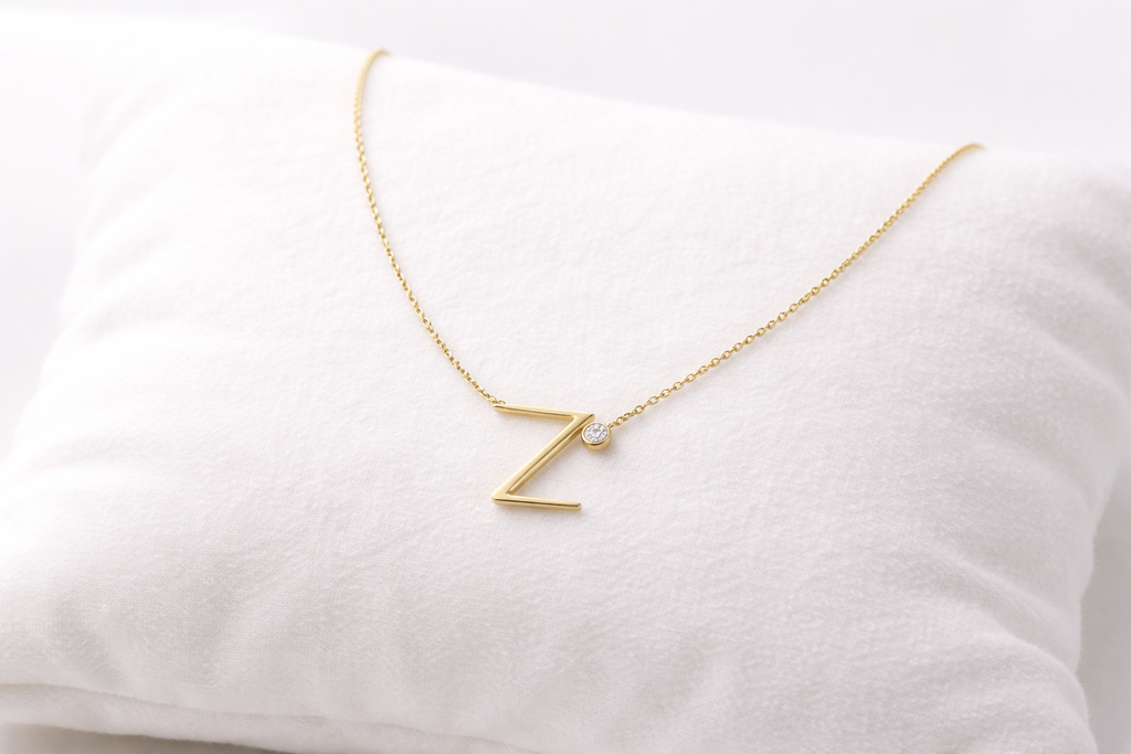 Gold necklace with a 'Z' pendant on a white background