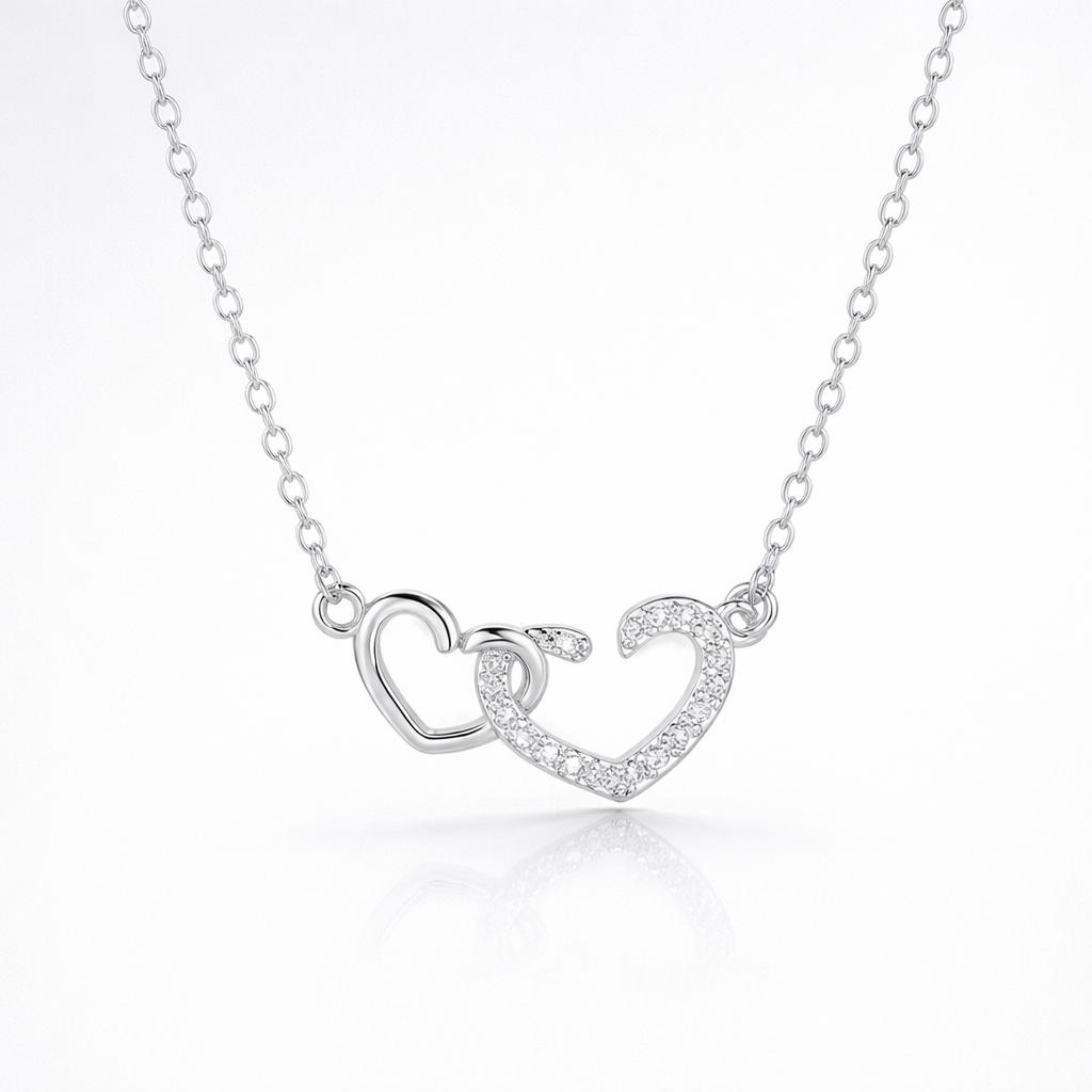 Silver necklace with a heart-shaped pendant on a white background