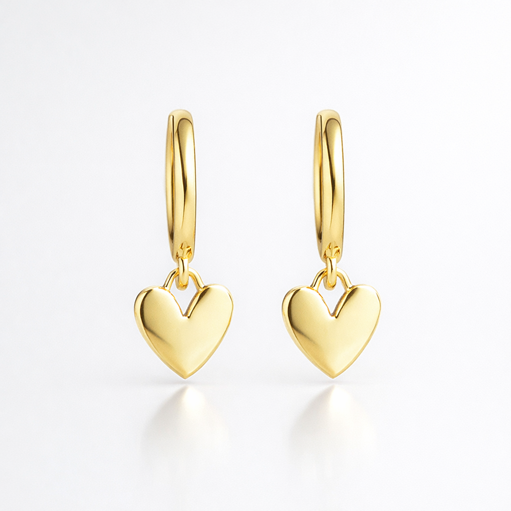 Gold heart-shaped earrings on a white background
