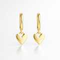 Gold heart-shaped earrings on a white background