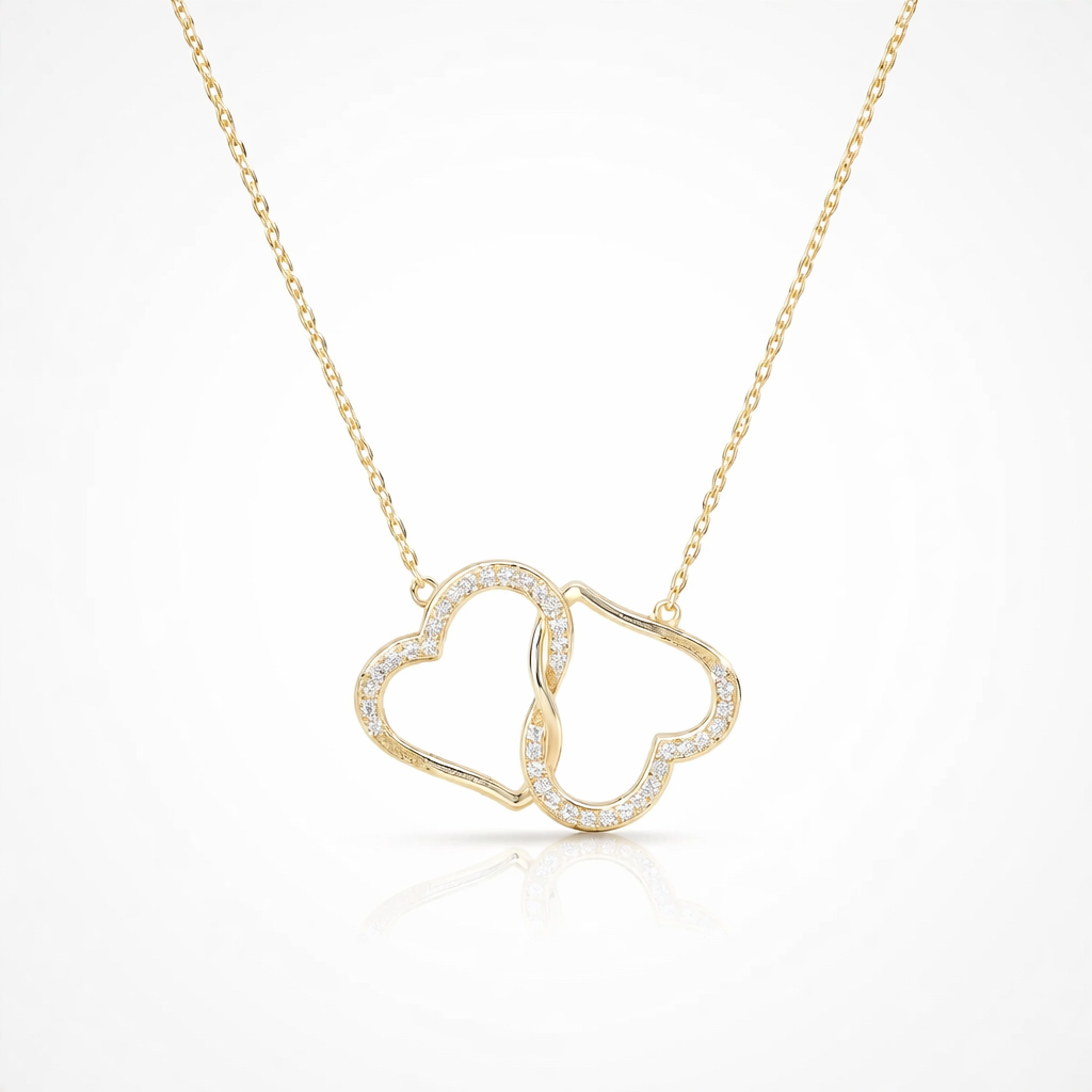 Gold necklace with a heart-shaped pendant on a white background