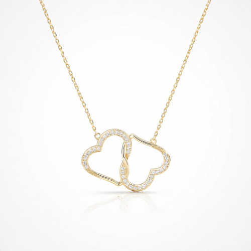 Gold necklace with a heart-shaped pendant on a white background