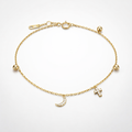 Gold bracelet with charms on a light gray background