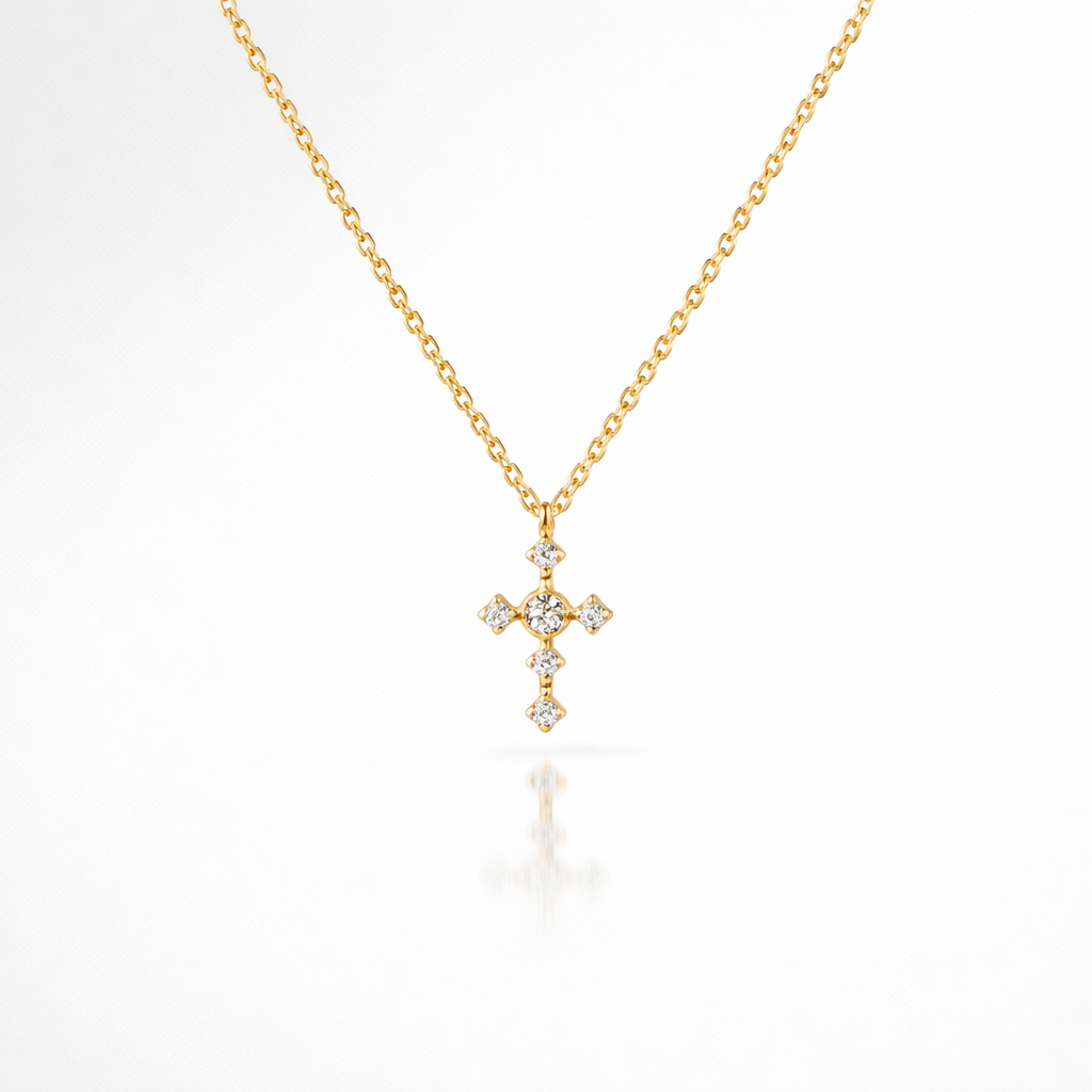 Gold cross necklace with diamonds on a white background
