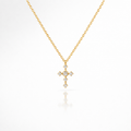 Gold cross necklace with diamonds on a white background