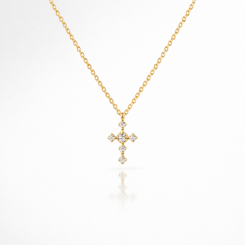 Gold cross necklace with diamonds on a white background