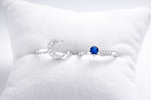 Silver ring with a blue gemstone on a white cushion