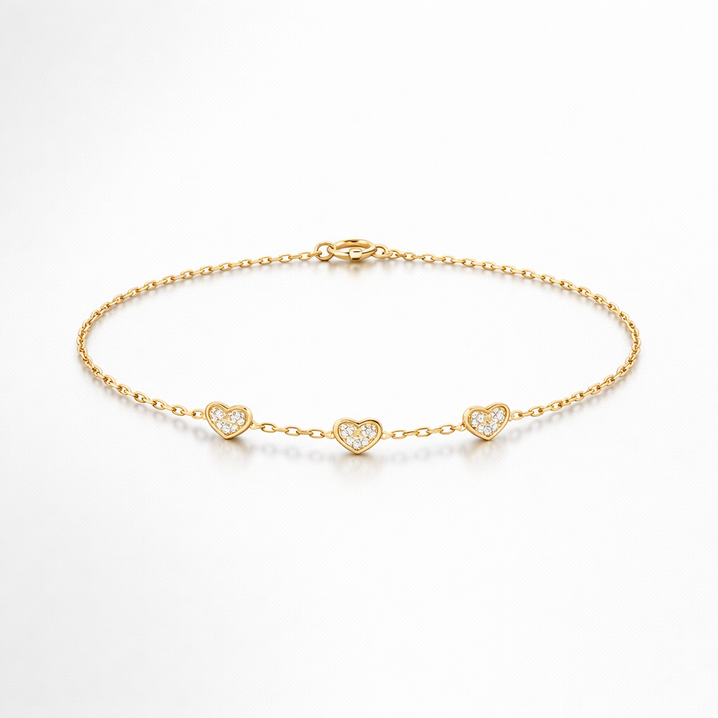 Gold bracelet with heart-shaped charms on a white background