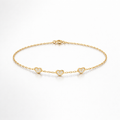 Gold bracelet with heart-shaped charms on a white background
