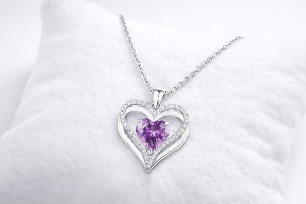 Heart-shaped necklace with a purple gemstone on a white background