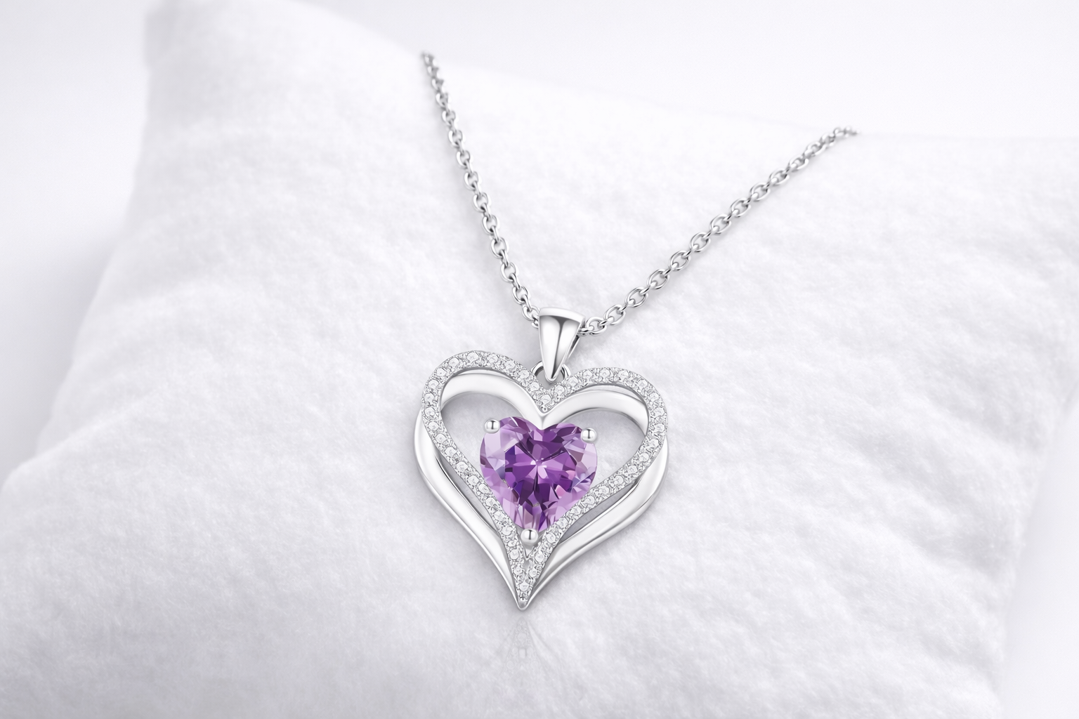 Heart-shaped necklace with a purple gemstone on a white background