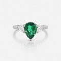 Ring with a green gemstone on a white background