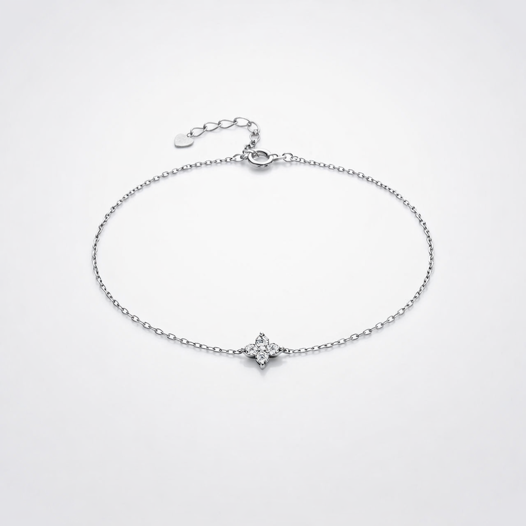 Silver bracelet with a star-shaped clasp on a light gray background