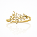 Gold ring with diamond accents on a white background