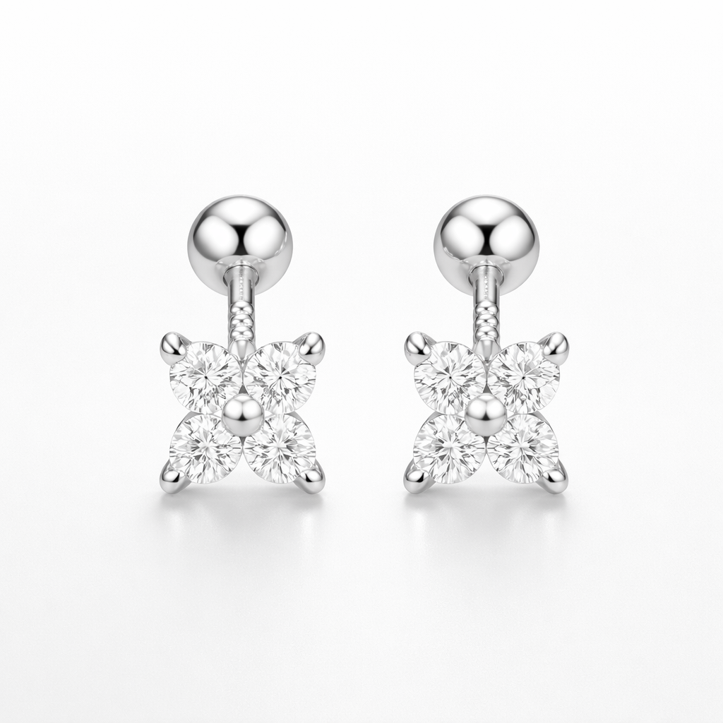 Pair of silver earrings with star-shaped clear gemstones on a white background
