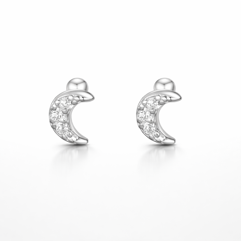 Silver moon-shaped earrings with small diamonds on a white background