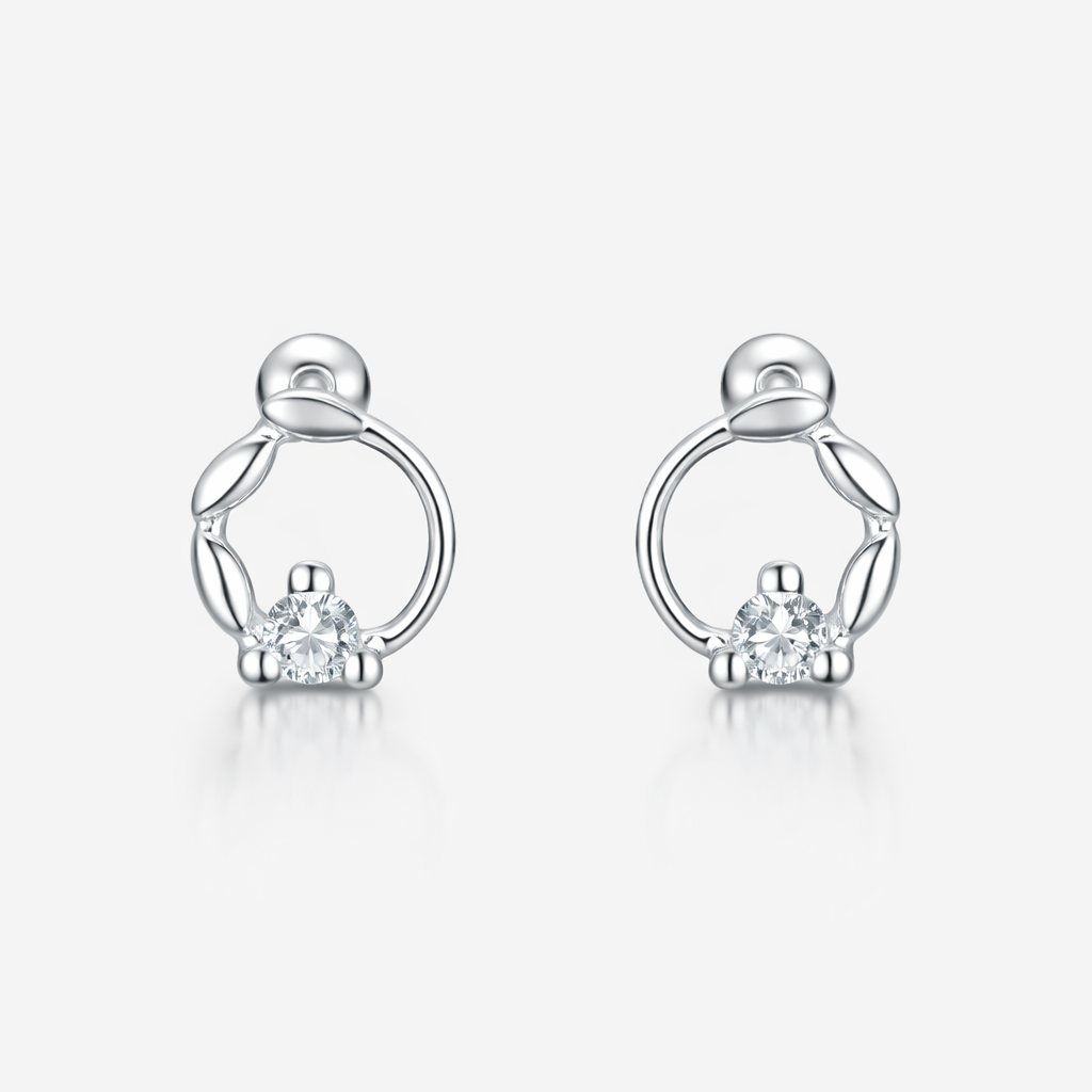 Pair of silver earrings with small diamonds on a white background