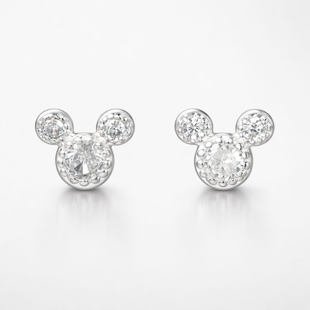 Mickey Mouse-shaped earrings with clear gemstones on a white background