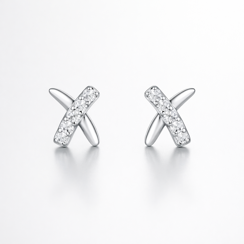 Pair of silver earrings with X design on a white background