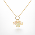 Gold necklace with three teardrop-shaped gemstones on a white background
