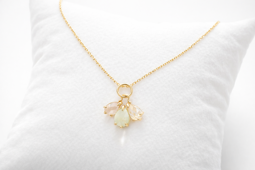 Gold necklace with a pendant on a white background