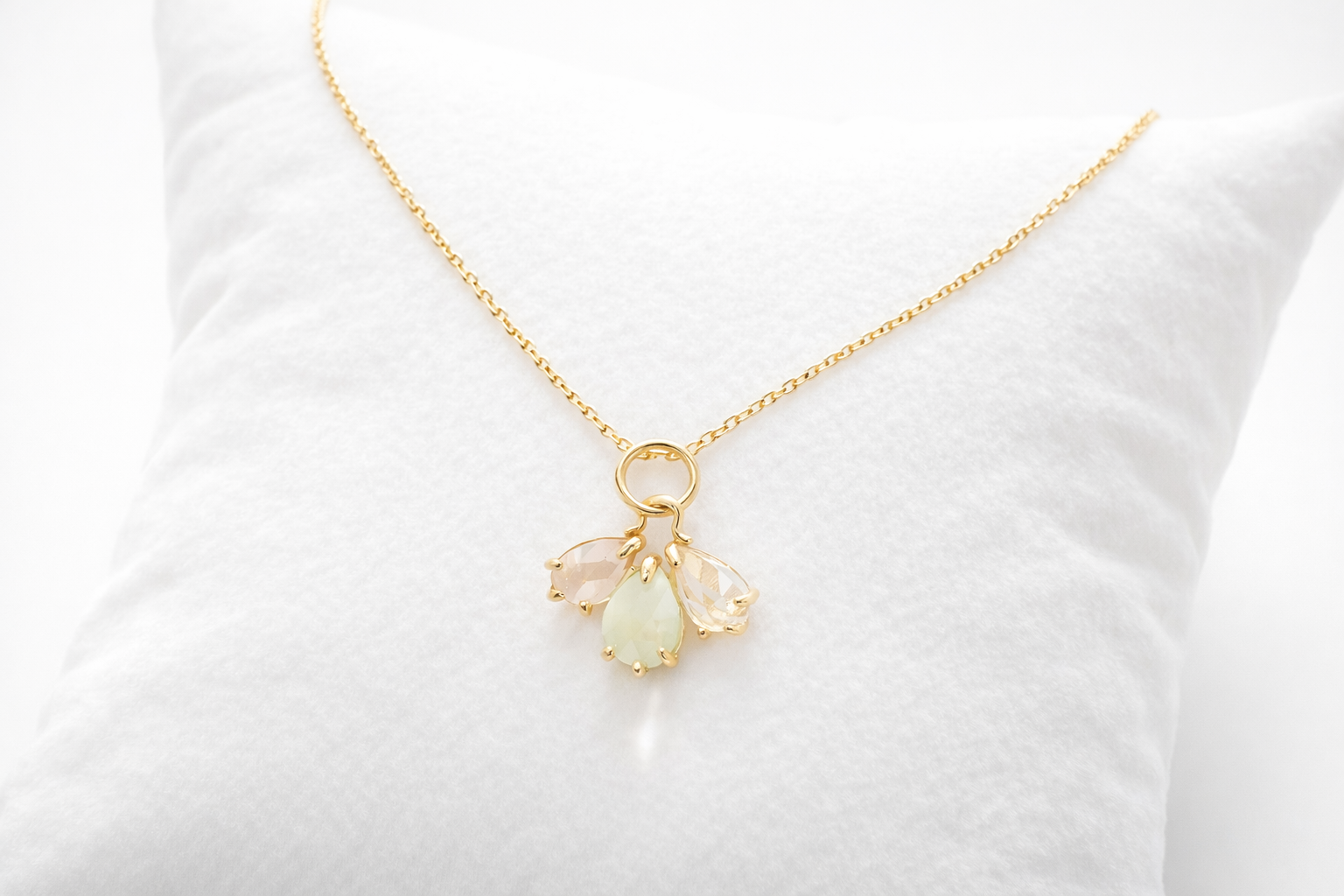 Gold necklace with a pendant on a white background