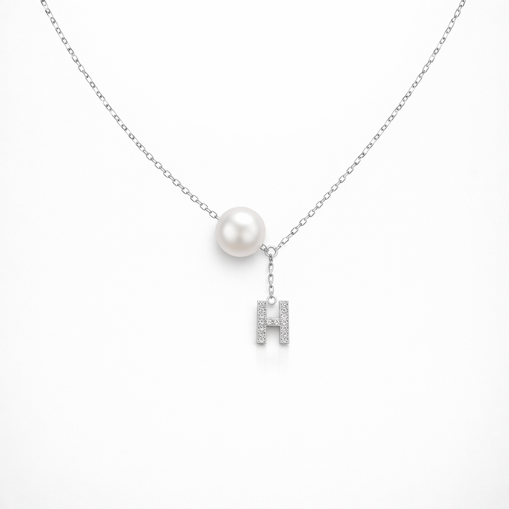 Necklace with a pearl pendant and 'H' letter charm on a white background