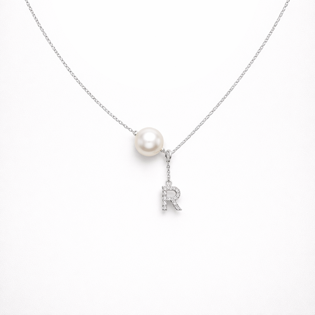 Pearl necklace with a letter 'R' pendant on a white background