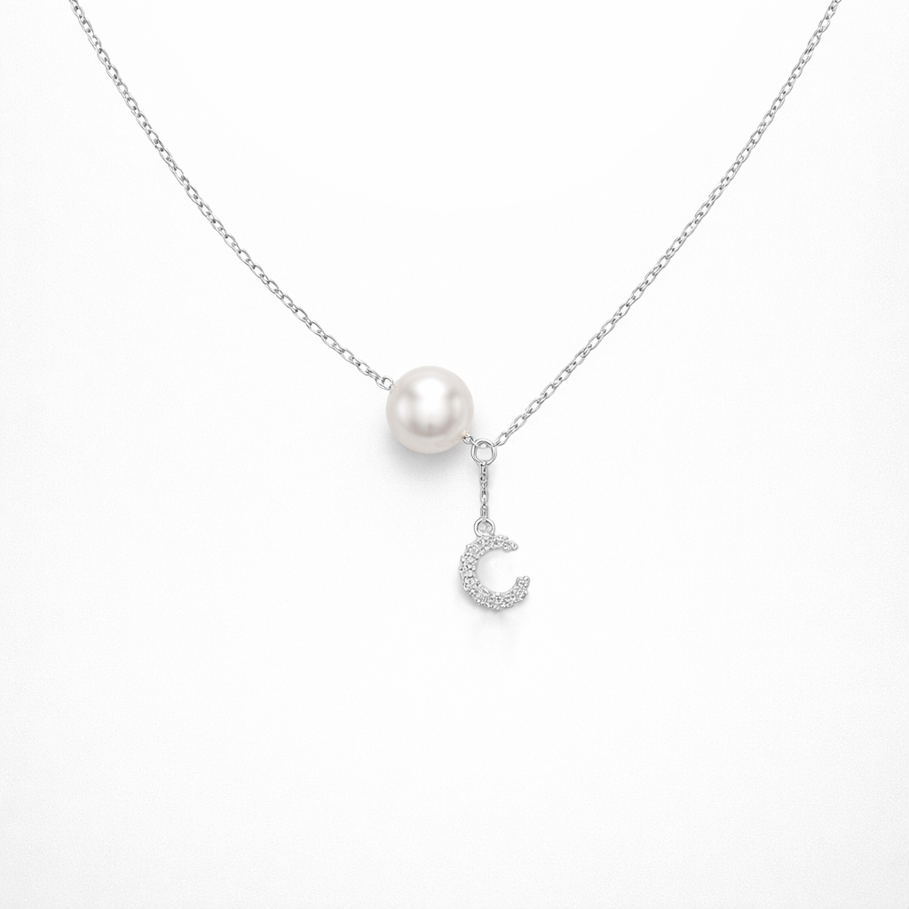 Pearl necklace with a moon-shaped pendant on a white background