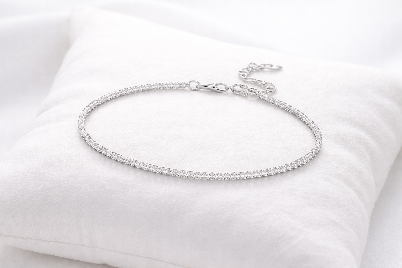 Silver bracelet on a white cushion