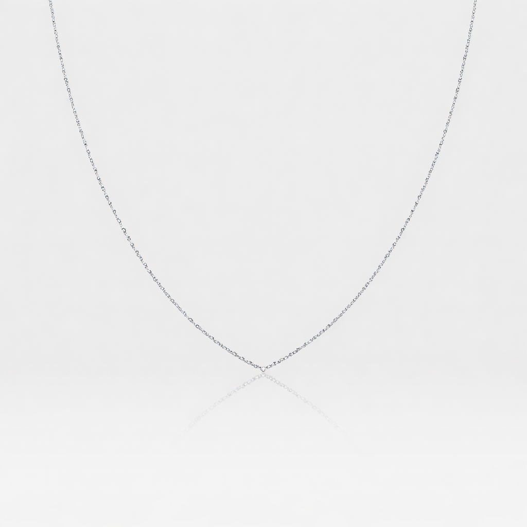 Silver chain necklace on a light gray background