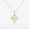 Gold necklace with a decorative pendant on a white background