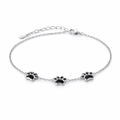 Silver bracelet with black paw print charms on a white background