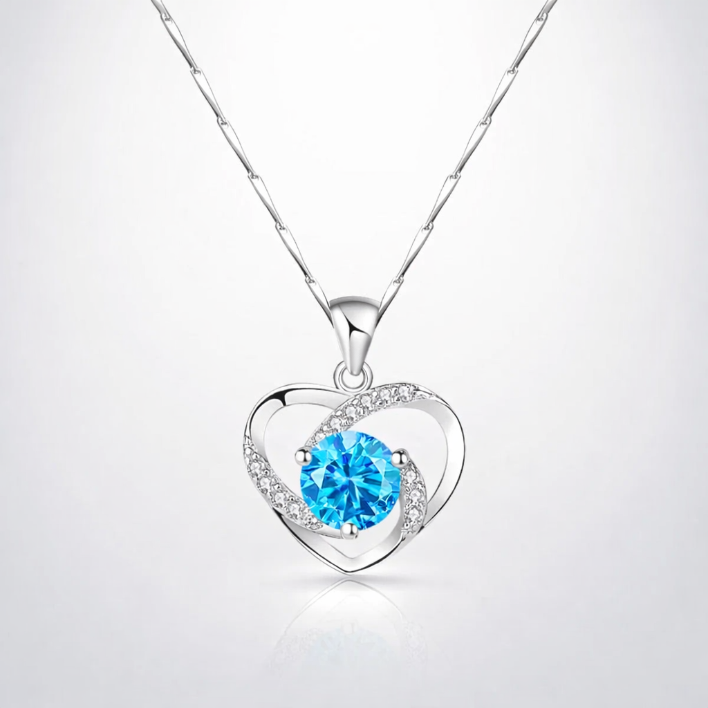 Heart-shaped necklace with a blue gemstone on a white background