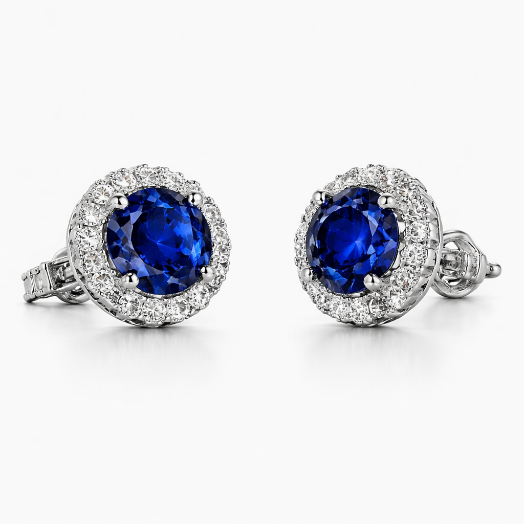 Pair of blue gemstone earrings with diamond accents on a white background
