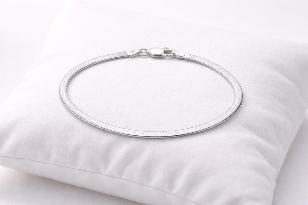 Silver necklace on a white pillow