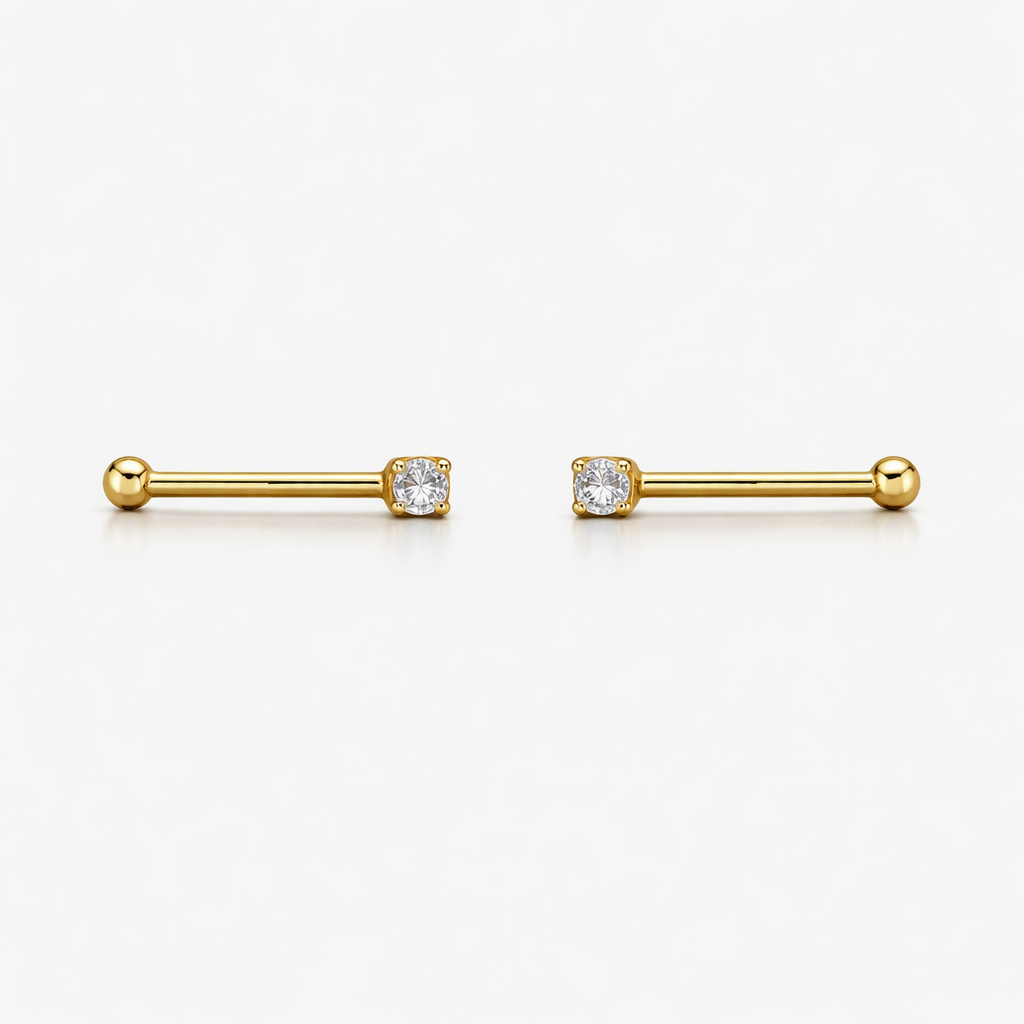 Gold bar earrings with clear gemstones on a white background