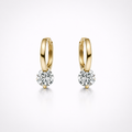 Gold hoop earrings with round gemstones on a white background
