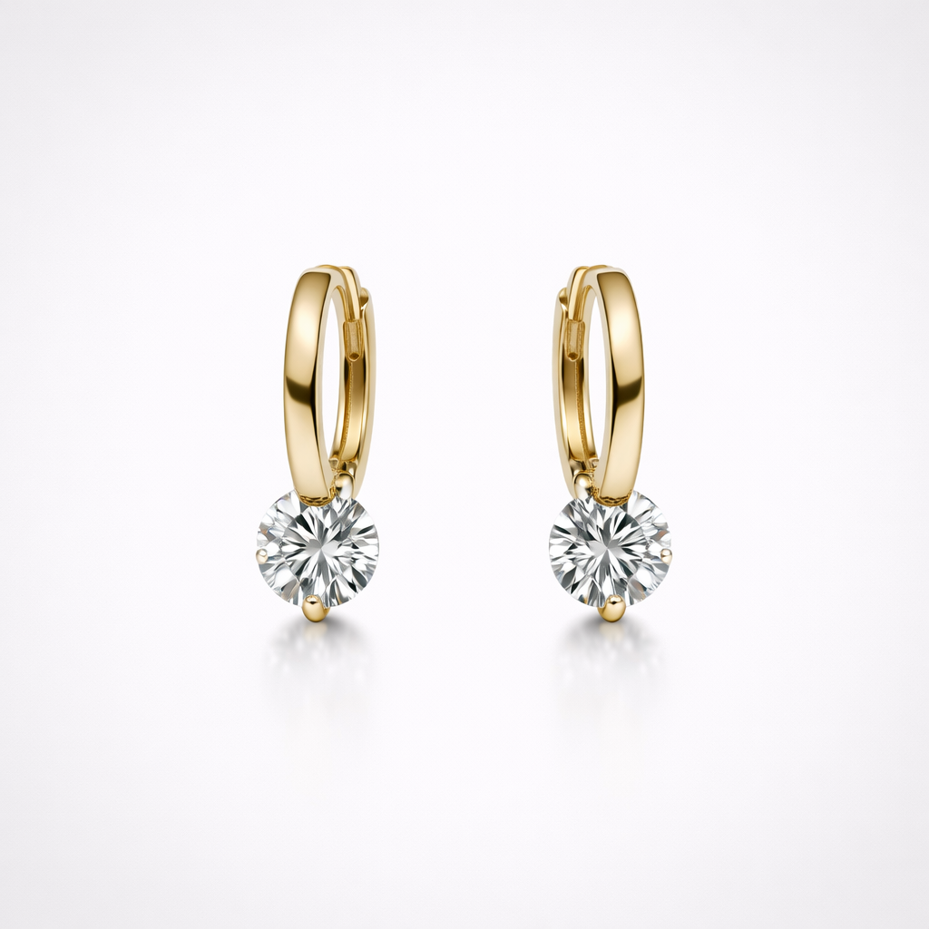 Gold hoop earrings with round gemstones on a white background