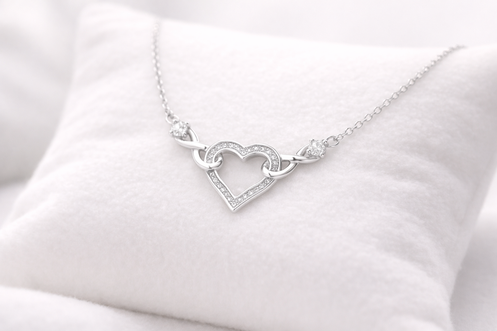 Silver heart-shaped necklace on a white cushion