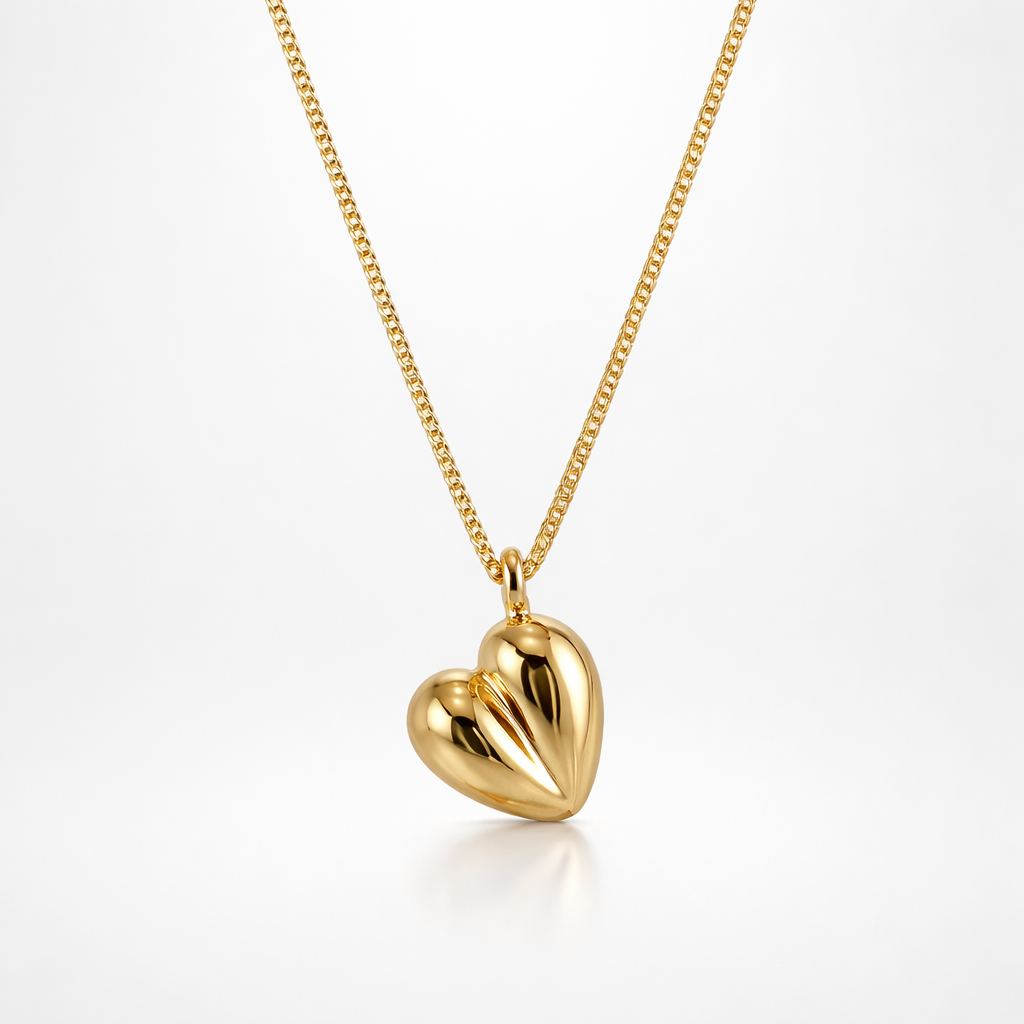 Gold heart-shaped pendant on a chain against a white background