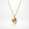 Gold heart-shaped pendant on a chain against a white background