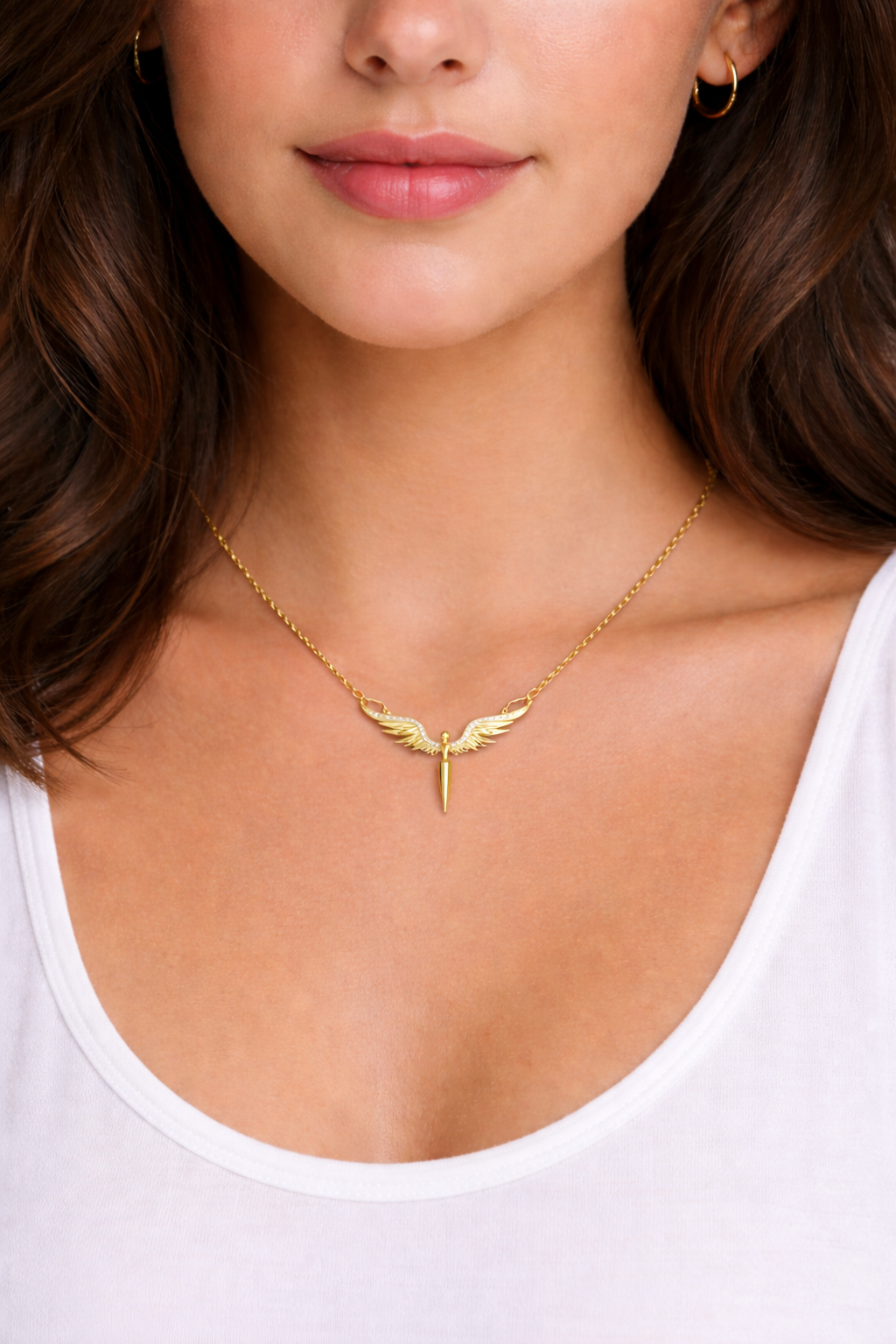 Gold necklace with a unique design worn by a person against a neutral background
