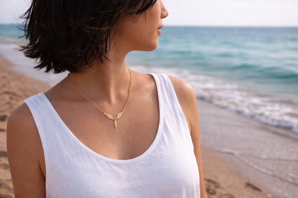 Woman wearing a gold necklace on a beach