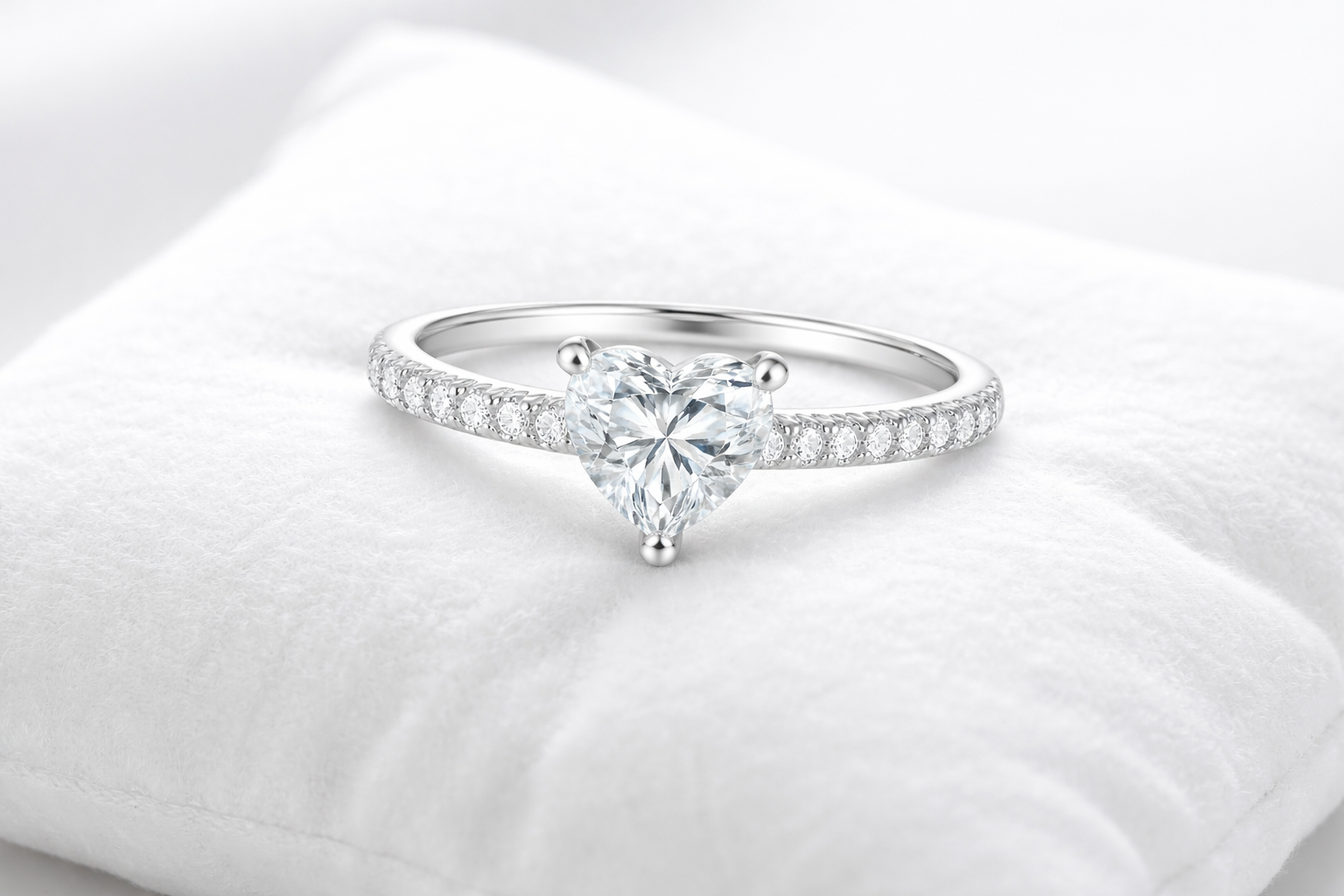 silver diamond ring on pillow