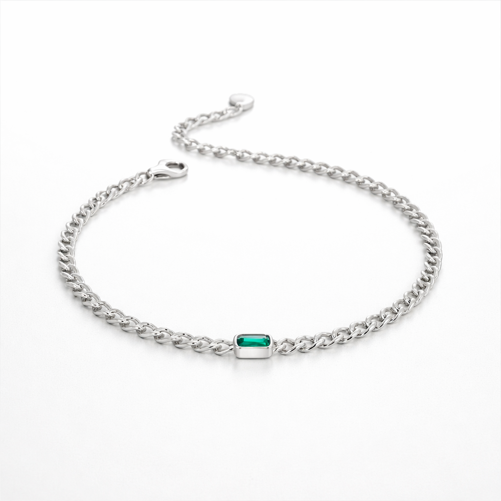 Silver bracelet with a green gemstone on a white background