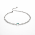 Silver bracelet with a green gemstone on a white background