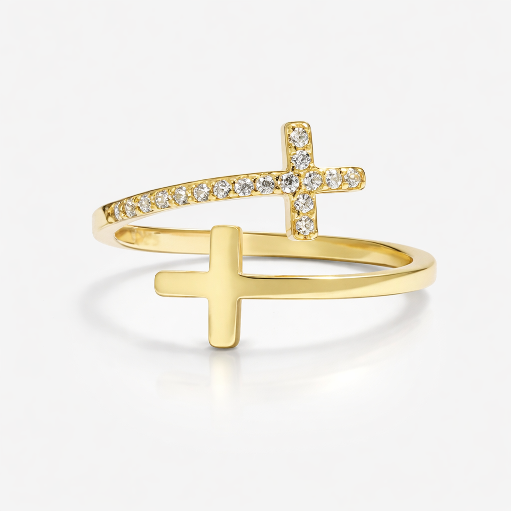 Gold ring with a cross design on a white background