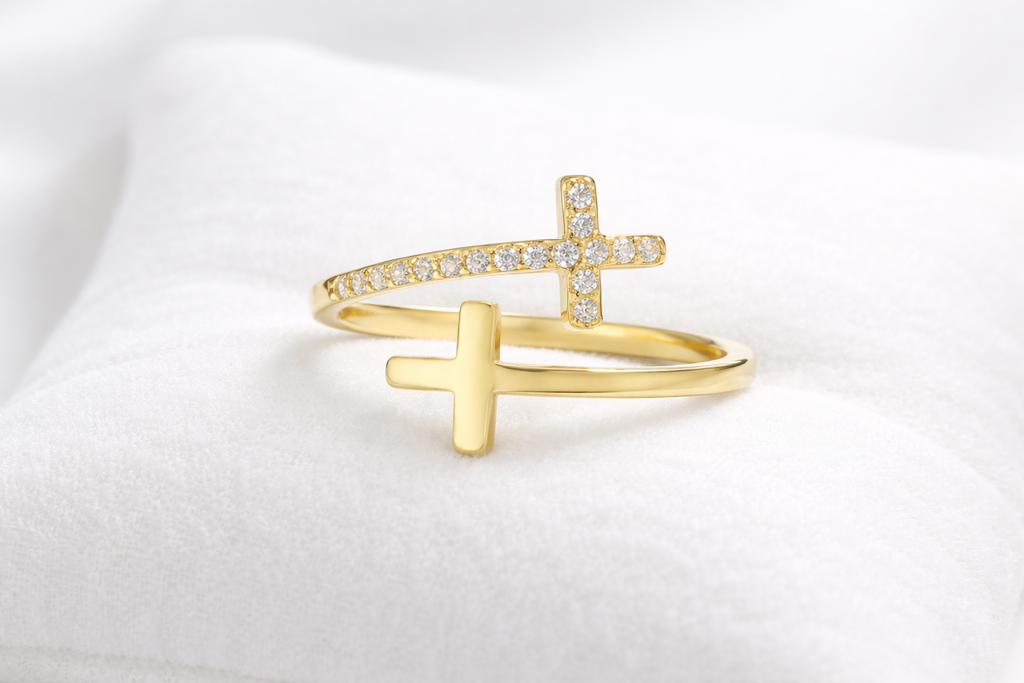 Gold ring with a cross design on a white background