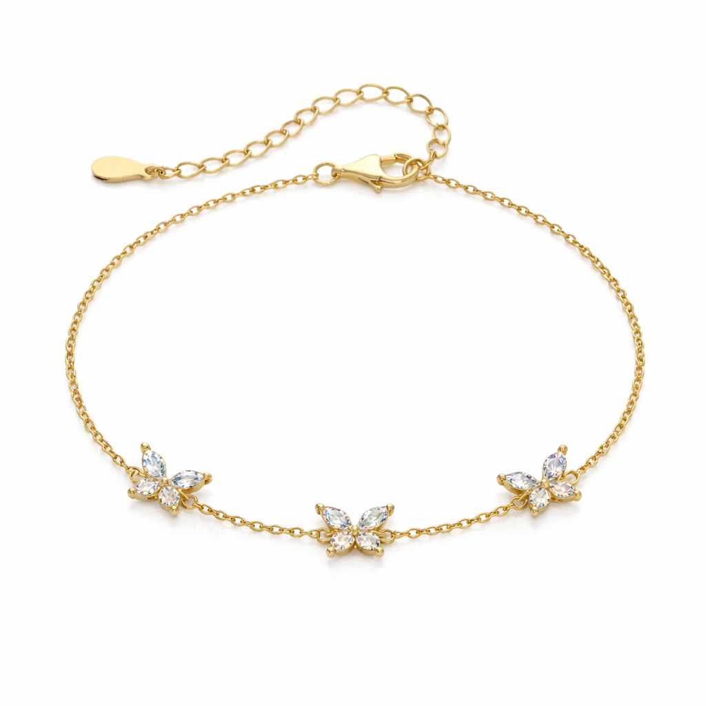 Gold bracelet with butterfly-shaped charms on a white background